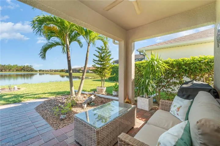 View of patio with an outdoor living space, a water view, and ceiling fan