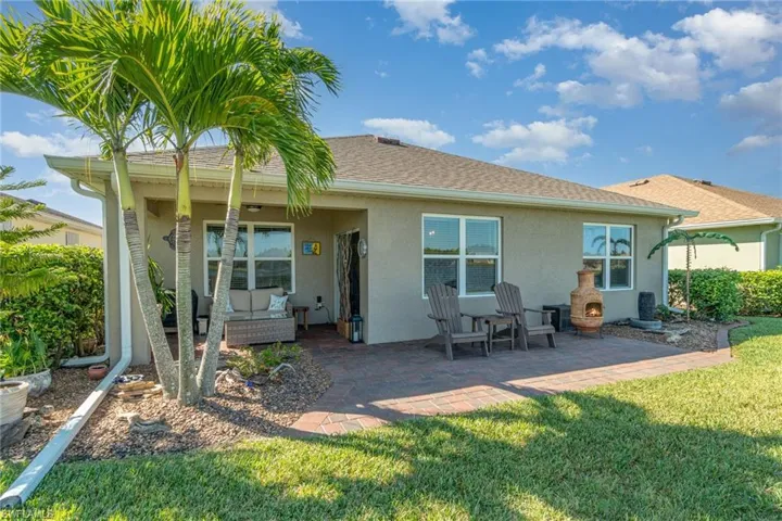Rear view of house featuring a yard and a patio area