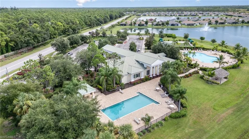 Birds eye view of property with a water view