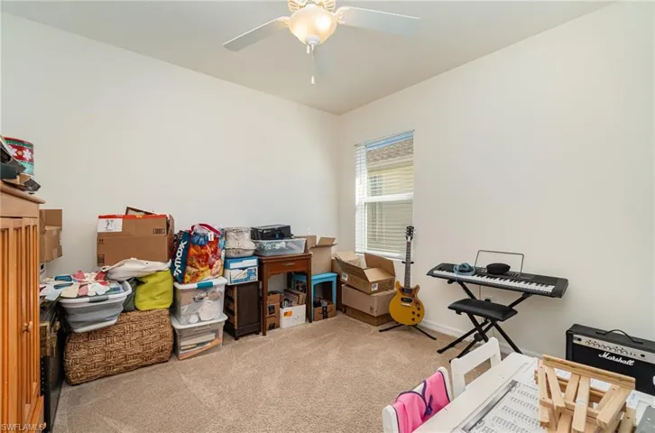 Miscellaneous room featuring ceiling fan and carpet floors