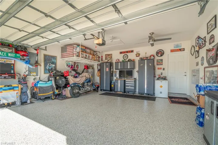 Garage featuring a garage door opener and ceiling fan