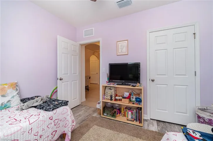 Bedroom with light vinyl flooring