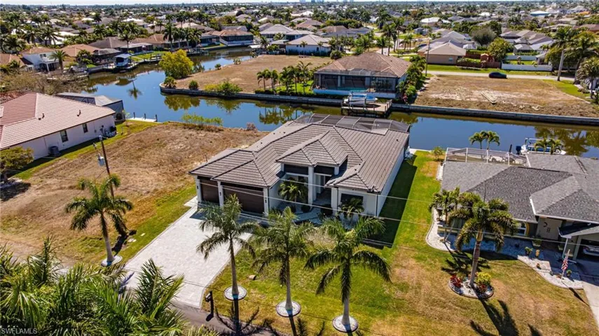 Aerial perspective of suburban area featuring a nearby body of water