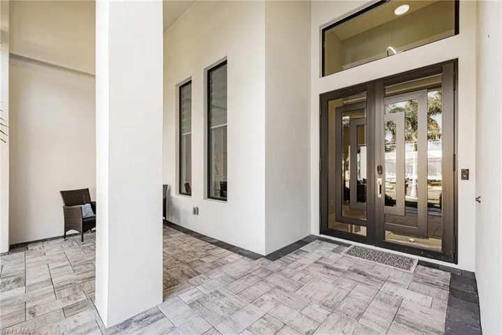 View of exterior entry with french doors and stucco siding