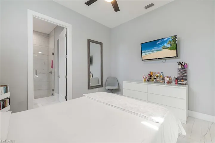 Bedroom with light marble finish flooring and ceiling fan