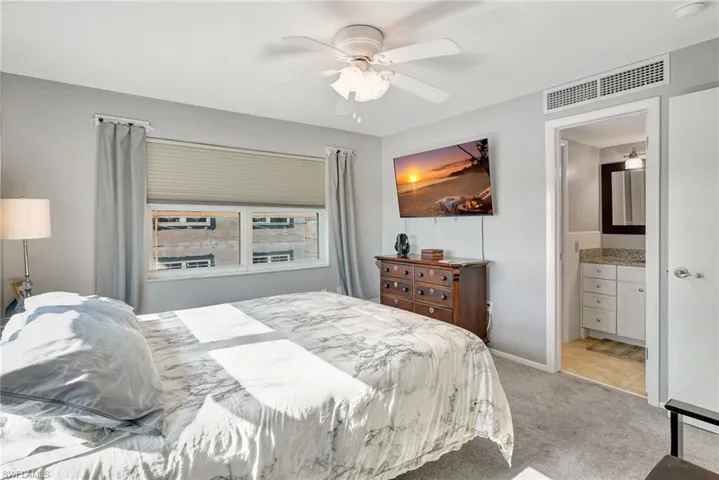 Master Bedroom featuring TV, ceiling fan, ensuite bath & walk-in closet