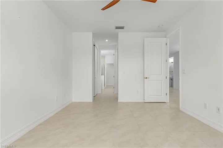 Unfurnished bedroom featuring ceiling fan and light tile patterned floors