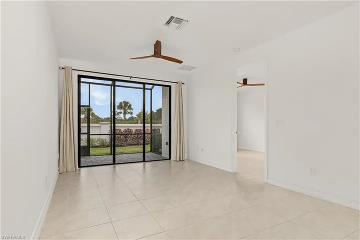 Tiled empty room featuring ceiling fan
