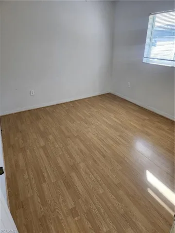 Spare room with light wood-type flooring and baseboards