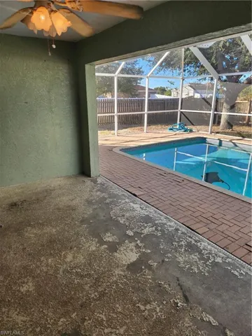 View of pool with a fenced backyard, a sunroom, a lanai, and a patio area
