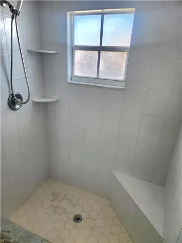 Full bath featuring a shower stall