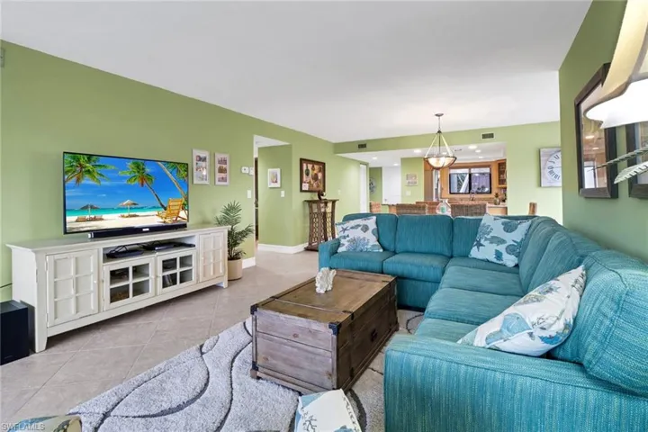 Tiled living room featuring a chandelier