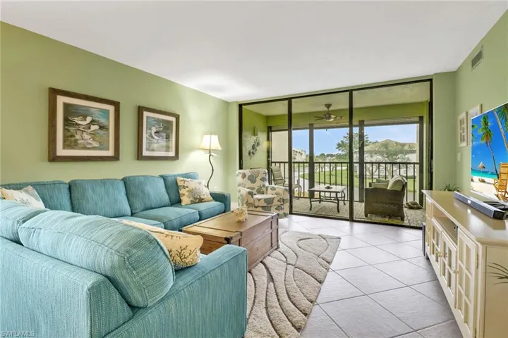 Tiled living room with floor to ceiling windows