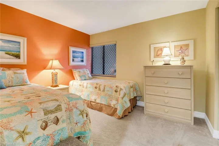 Bedroom featuring light carpet