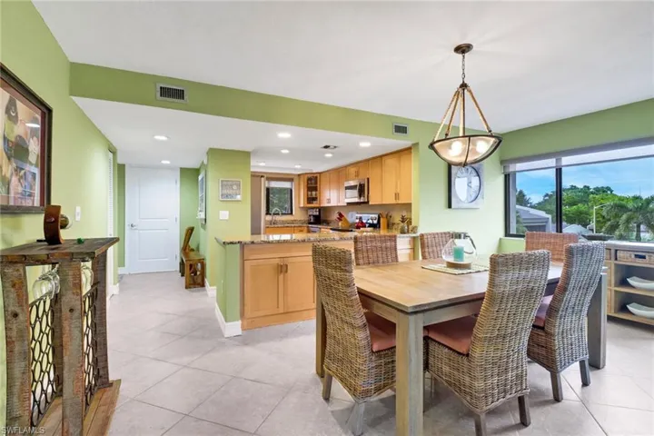 Dining area with sink and light tile patterned flooring
