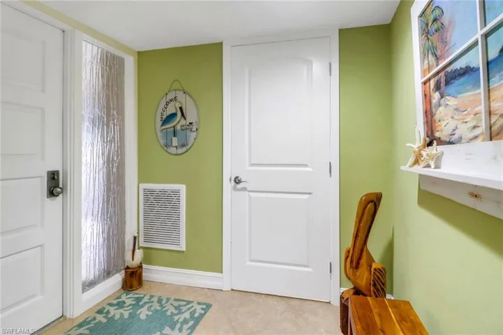 Entrance foyer with light tile patterned floors