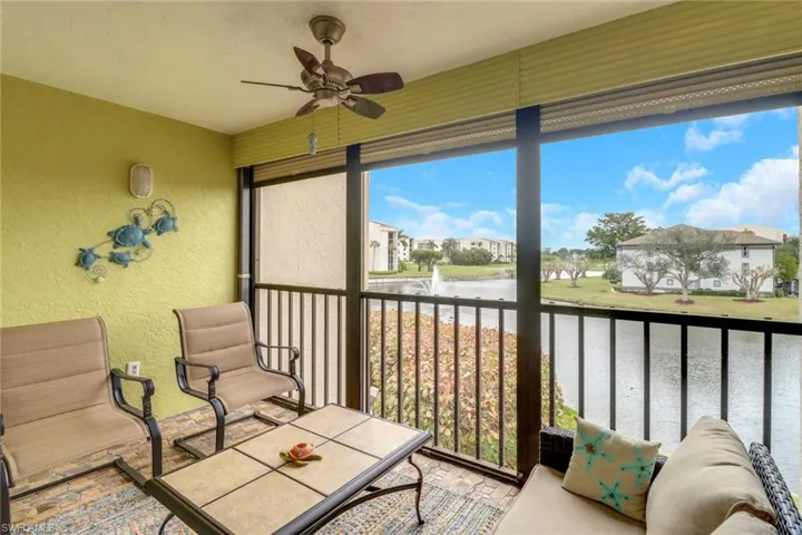Sunroom featuring a water view and ceiling fan