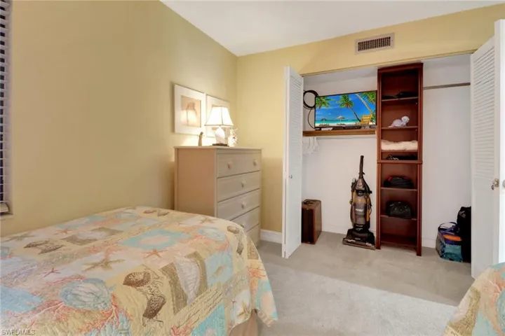 Bedroom featuring light carpet