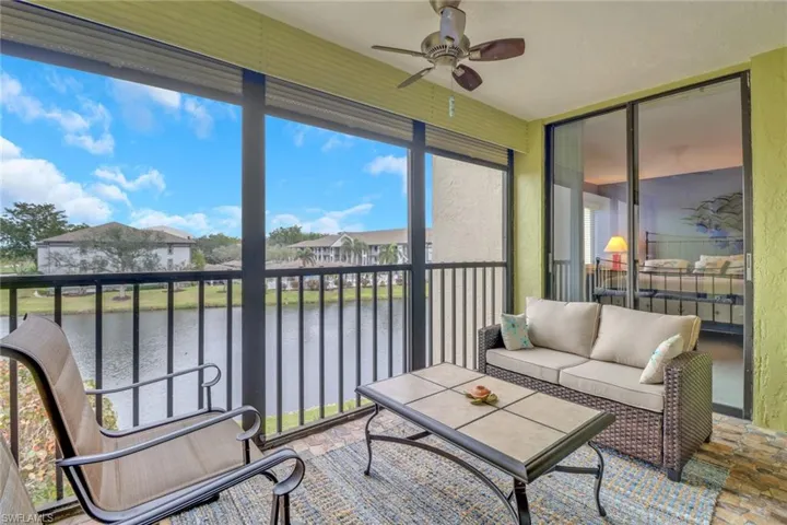 Sunroom featuring ceiling fan and a water view