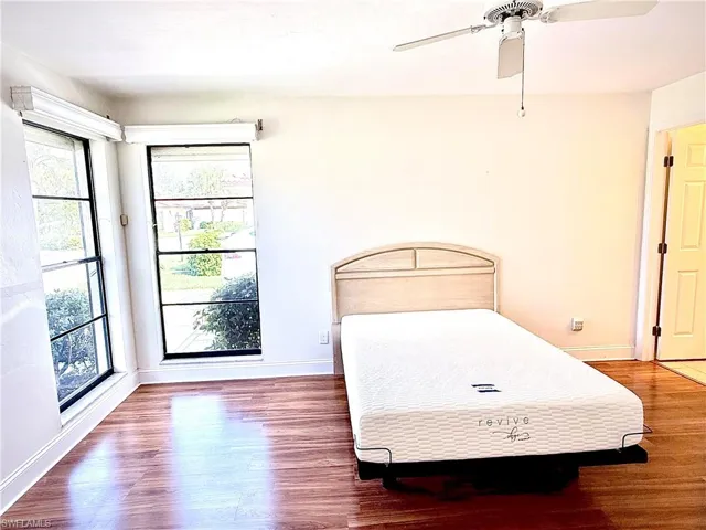 Bedroom featuring wood-type flooring and ceiling fan