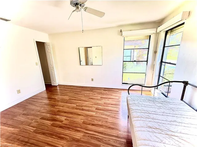 Unfurnished bedroom featuring hardwood / wood-style flooring
