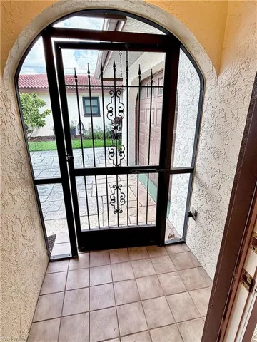 Doorway to outside with tile patterned floors