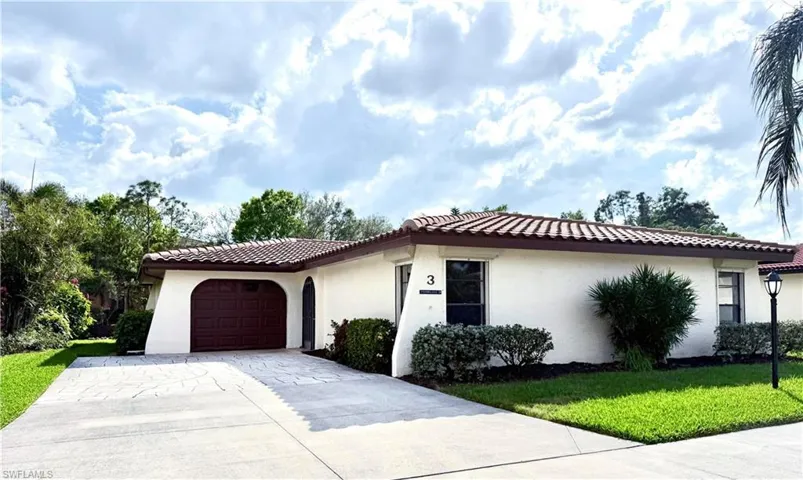 Mediterranean / spanish house with a garage and a front lawn