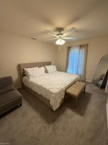 Bedroom with carpet flooring and ceiling fan