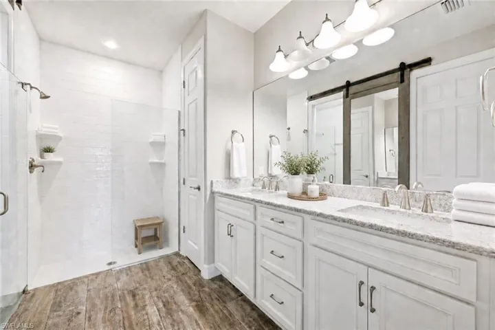 Dual vanity with light-toned countertop, undermount sinks, and brushed nickel fixtures
