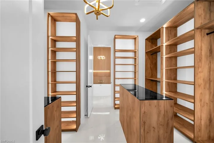 Spacious closet featuring a chandelier