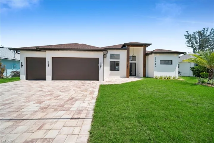 Prairie-style house with a front lawn and a garage