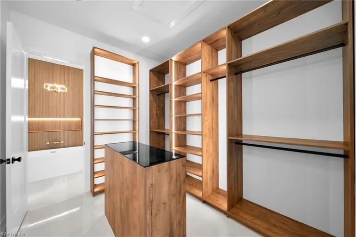 Spacious closet featuring light tile patterned flooring