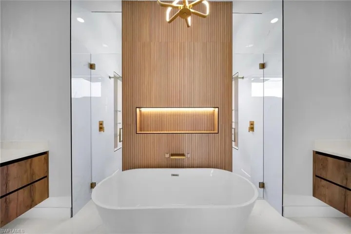 Bathroom with tile patterned floors, separate shower and tub, and vanity
