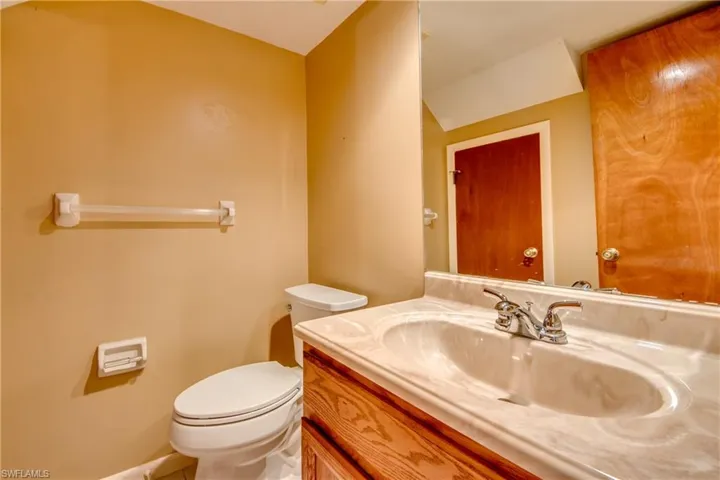 Main floor Bathroom featuring vanity and toilet
