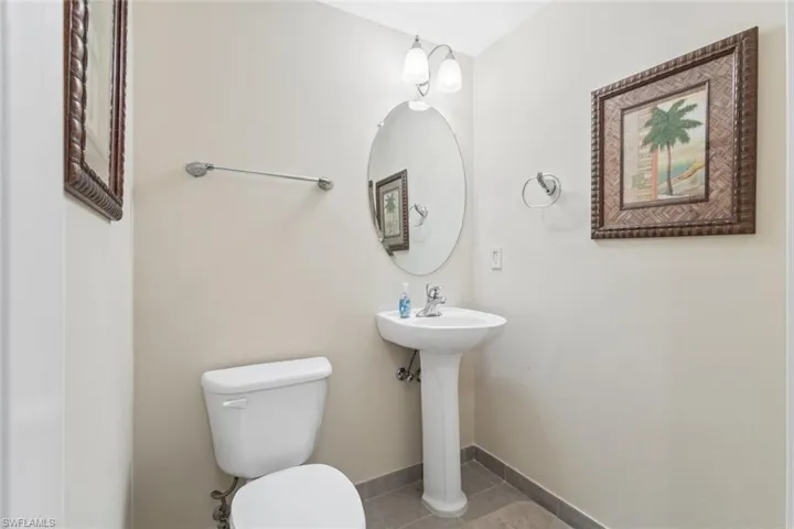 Bathroom with baseboards and tile patterned floors