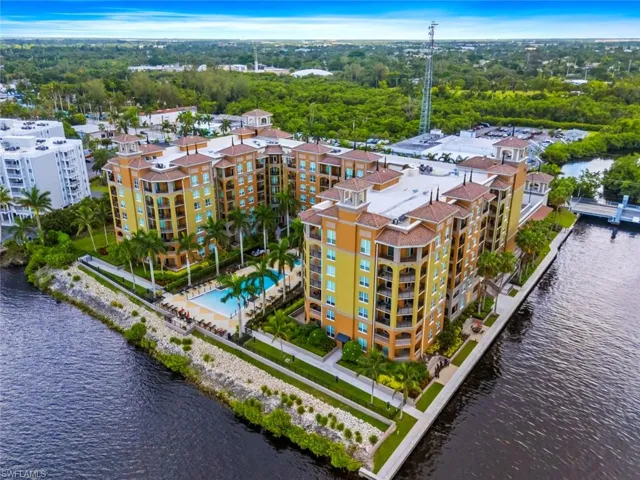 Drone / aerial view of a large body of water and apartment complex