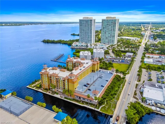 View of urban area with a nearby body of water and apartment complex / building