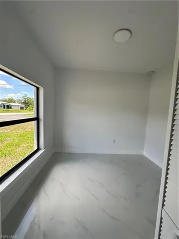 Spare room with baseboards and marble finish flooring