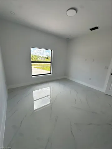 Spare room with baseboards and marble finish flooring