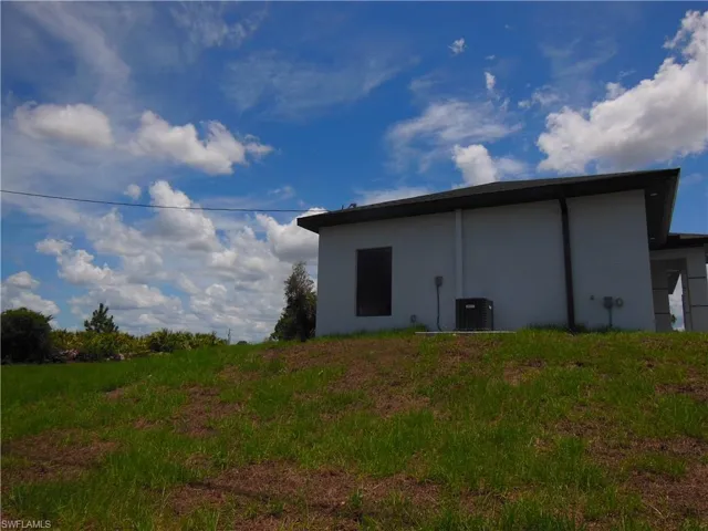Rear view of house featuring stucco siding