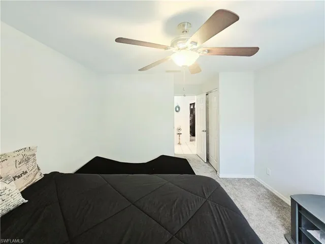 Bedroom featuring light carpet and ceiling fan