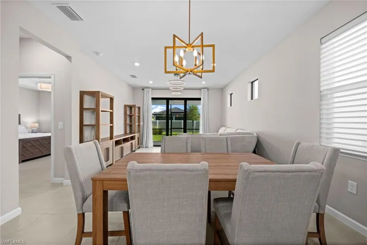 Dining area with recessed lighting and a chandelier