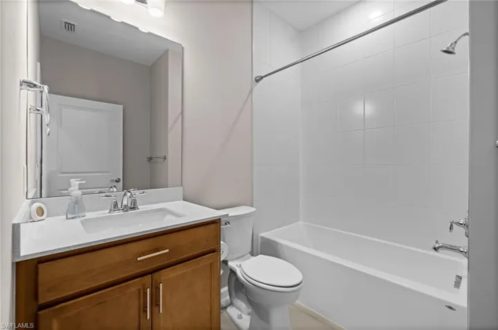 Bathroom with vanity and shower / washtub combination