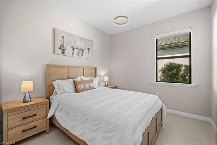 Bedroom featuring light tile patterned flooring and baseboards