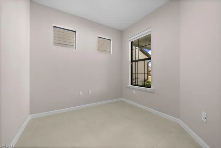 Unfurnished room featuring baseboards and light tile patterned floors