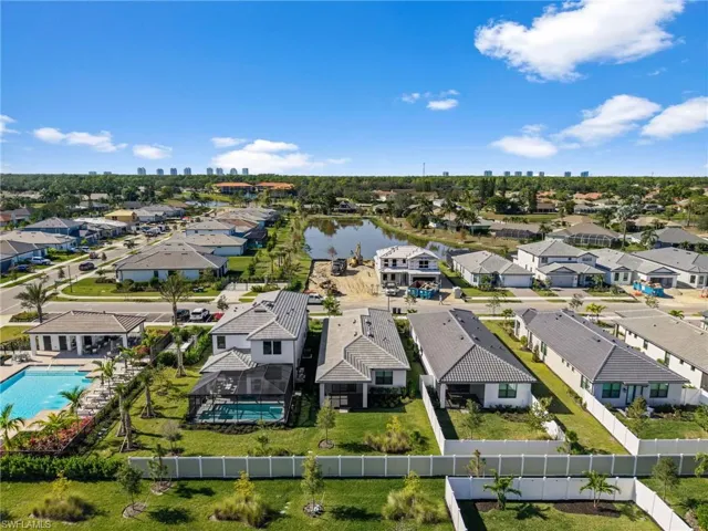 Aerial view of residential area featuring a large body of water and city skyline