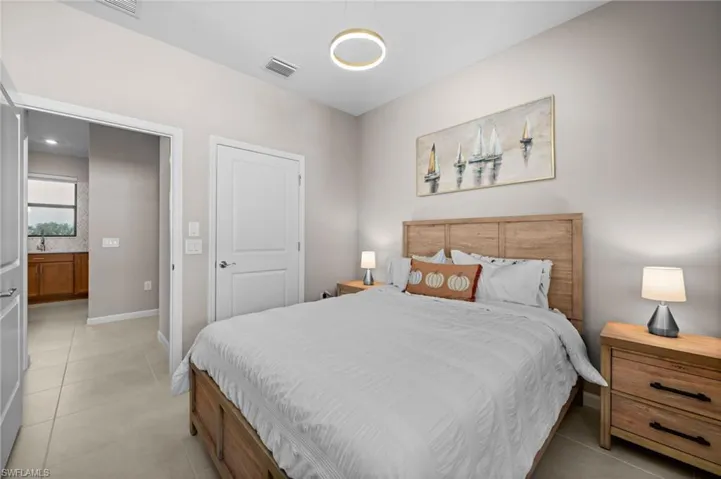 Bedroom featuring light tile patterned flooring and baseboards