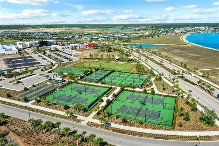 Aerial perspective showcasing multiple tennis courts, pickleball courts, and bocce ball courts