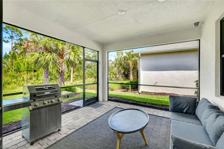 Screened outdoor living area featuring paver flooring
