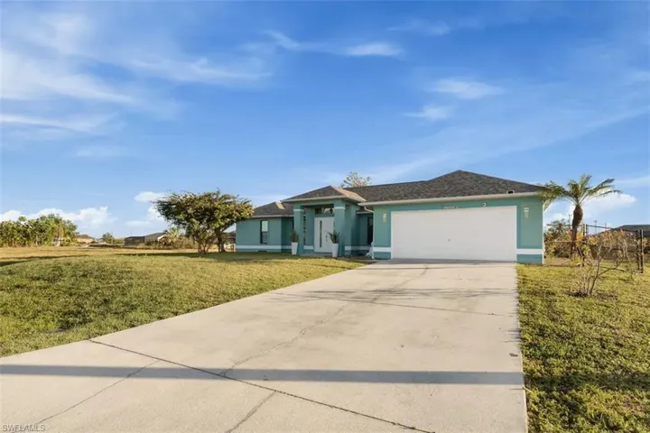 Ranch-style home with a garage and a front yard